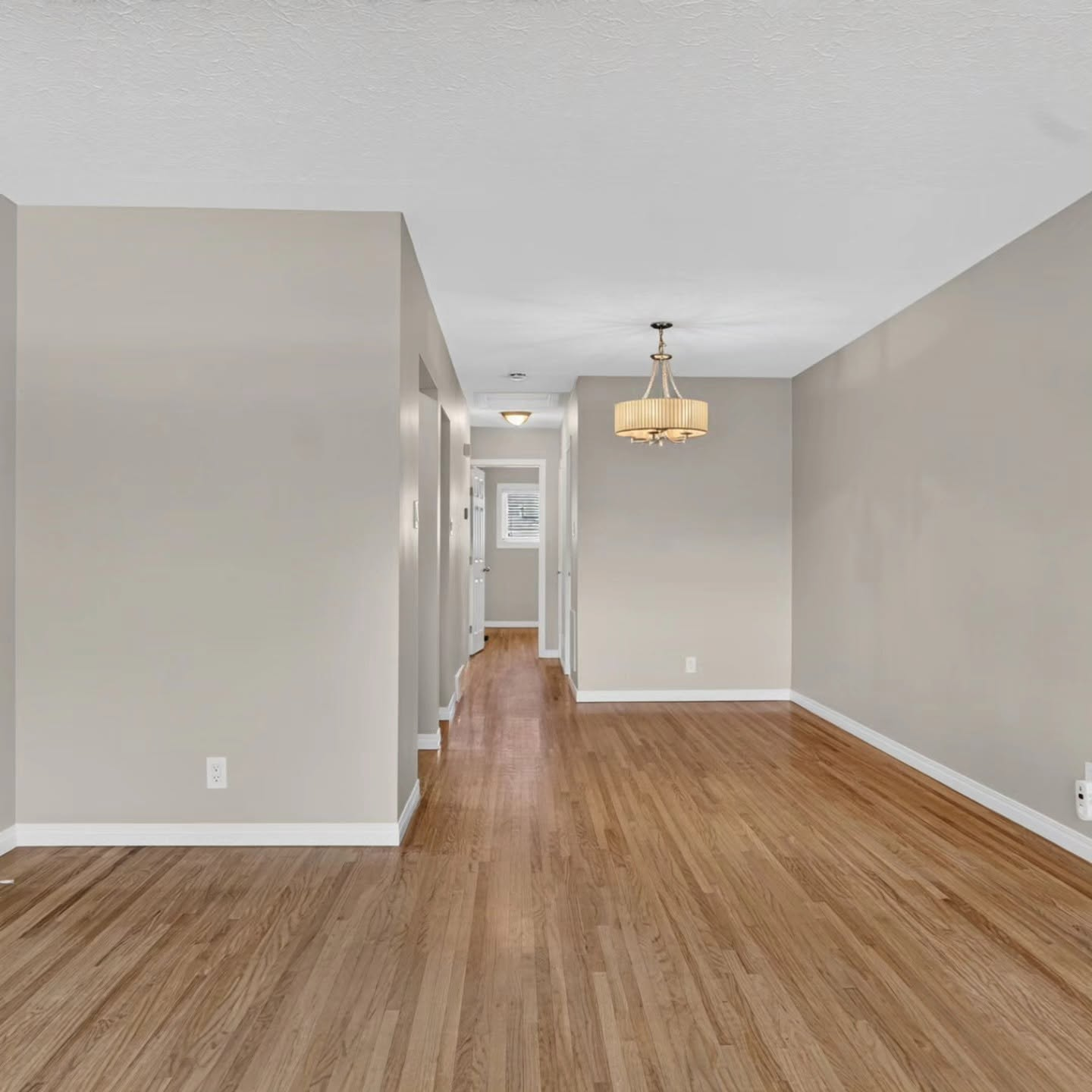 Freshly painted hallway and dining space in a Calgary home by Lady J's