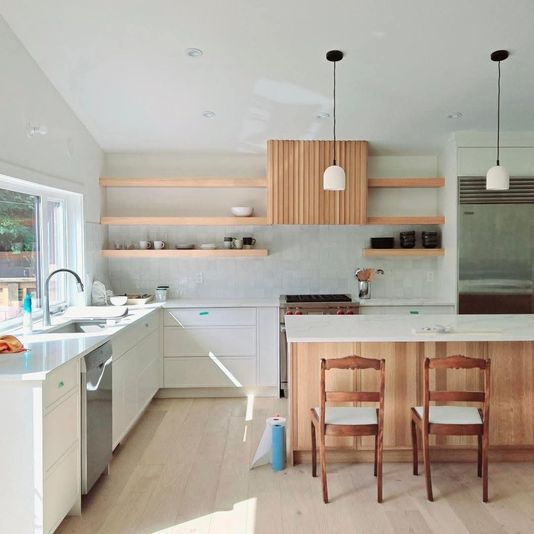 Interior painting services in Calgary by Lady J's Painting & Decorating Bright modern kitchen with freshly painted white cabinets and trim by Lady J's in Bridgeland, Calgary